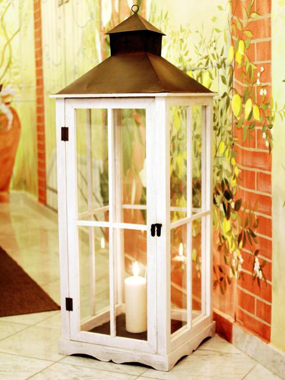 a lantern with a candle inside of it at Hotel La Pigna in Marina di Pietrasanta
