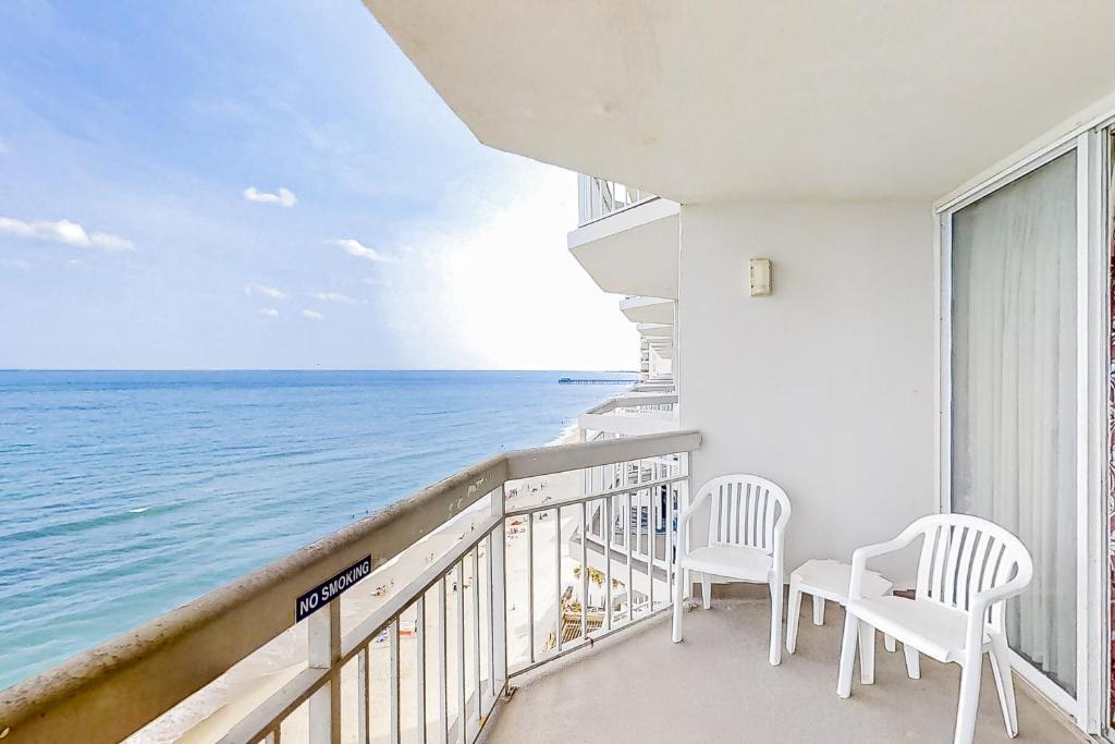 a balcony with two chairs and a view of the ocean at Water's Edge Resort 1002 in Myrtle Beach