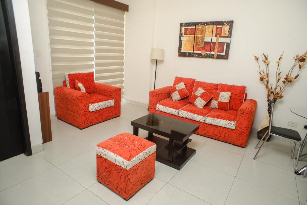 a living room with two couches and a table at Downtown Apartments "Altos del Sur" in Santa Cruz de la Sierra