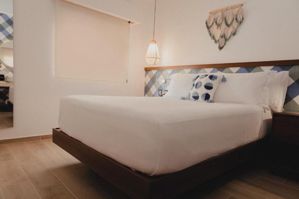 Postel nebo postele na pokoji v ubytování Nuxká Hotel
