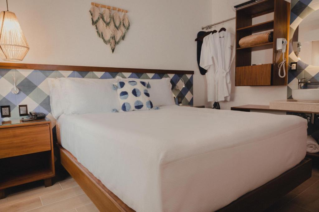 Postel nebo postele na pokoji v ubytování Nuxká Hotel