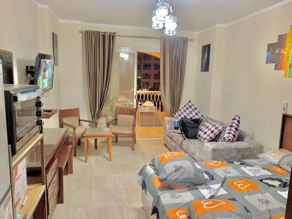 a living room with a couch and a living room with a couch at شالية استوديو 52 متر in Marsa Matruh