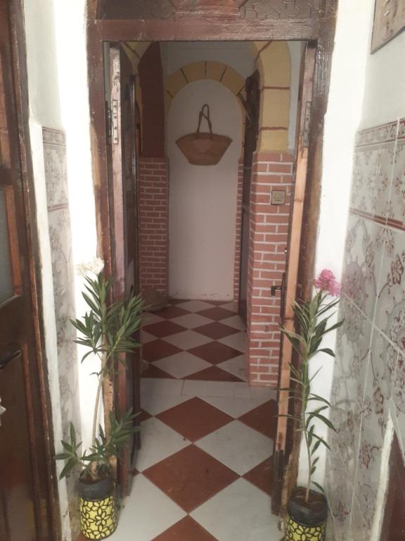a hallway in a house with a checkered floor at فرينة in Tafza