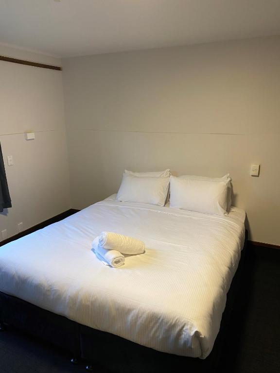 Postel nebo postele na pokoji v ubytování Pinewood Queenstown
