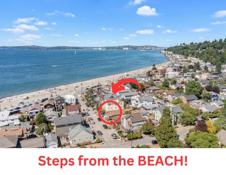 steps from the beach with a red sign on a beach at ALKI Retreat! Steps-2-BEACH - PARKING in Seattle