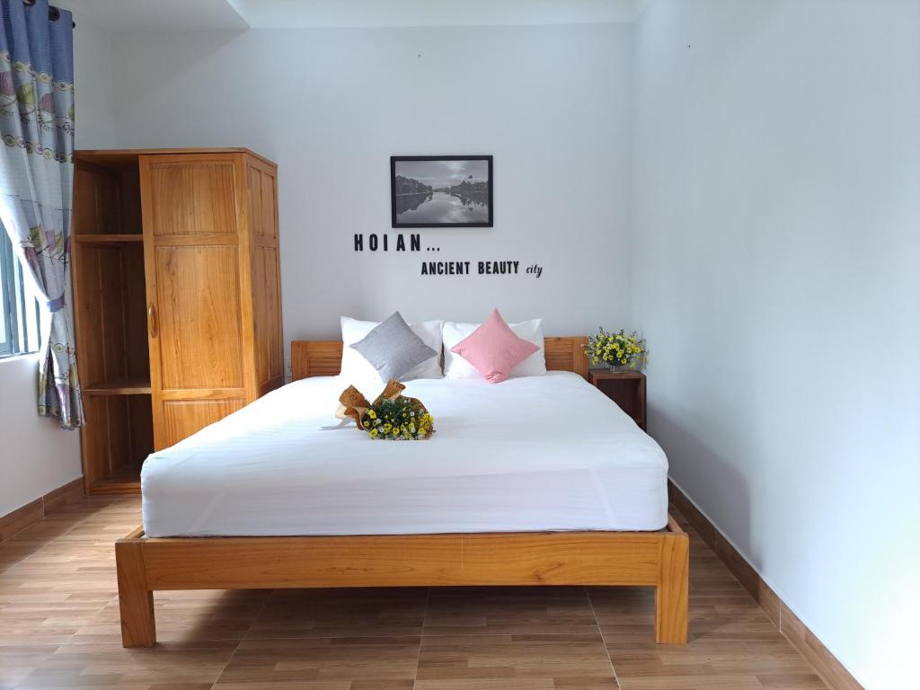 Postel nebo postele na pokoji v ubytování GREEN TOWN hotel HỘI AN