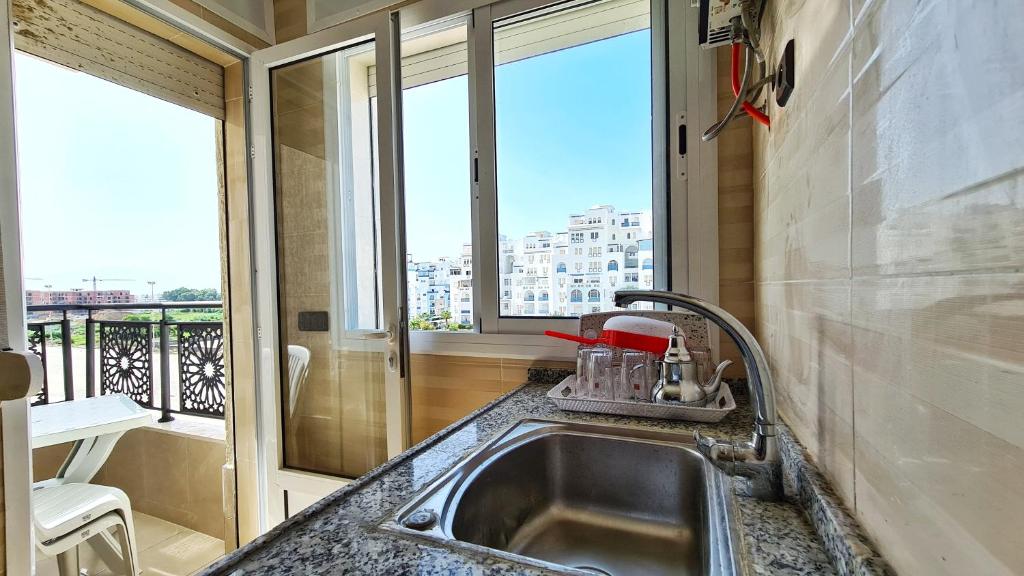 a kitchen with a sink and a window at Enjoy Your Vacation Here, Close to The Beach, Only 1 minute Walk!! in Martil