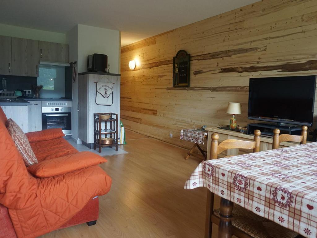 uma sala de estar com um sofá e uma mesa com uma televisão em Appartement Méaudre, 2 pièces, 4 personnes - FR-1-737-6 em Méaudre