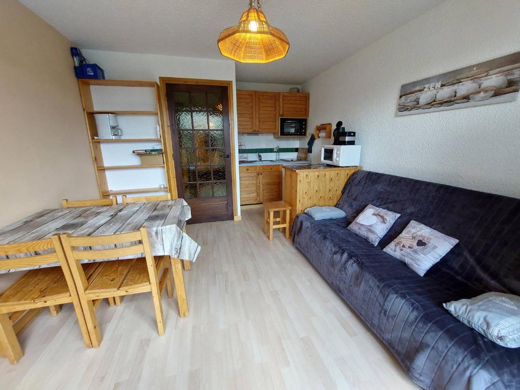 a living room with a couch and a table at Appartement Autrans, 2 pièces, 4 personnes - FR-1-737-19 in Autrans