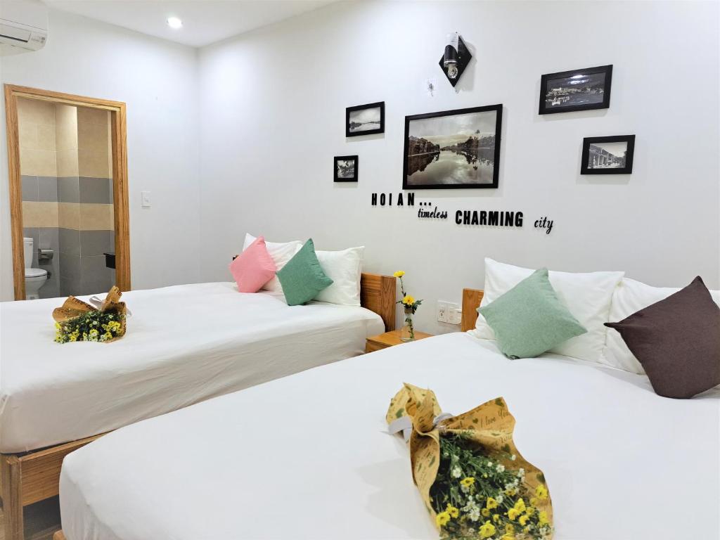Postel nebo postele na pokoji v ubytování GREEN TOWN hotel HỘI AN