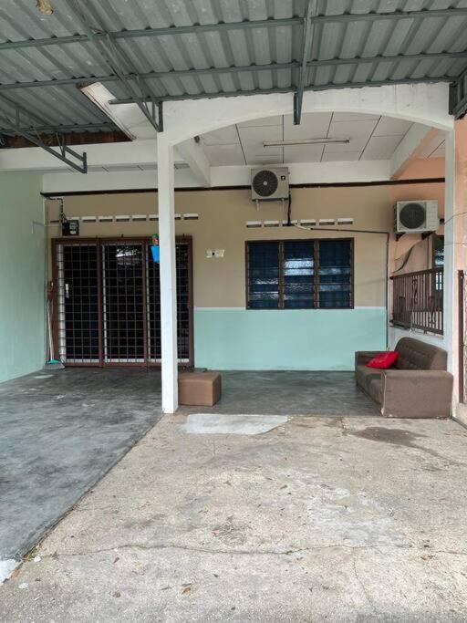 an empty parking garage with a couch and speakers at Hajjah Homestay Jln Rajawali Tg Agas in Muar