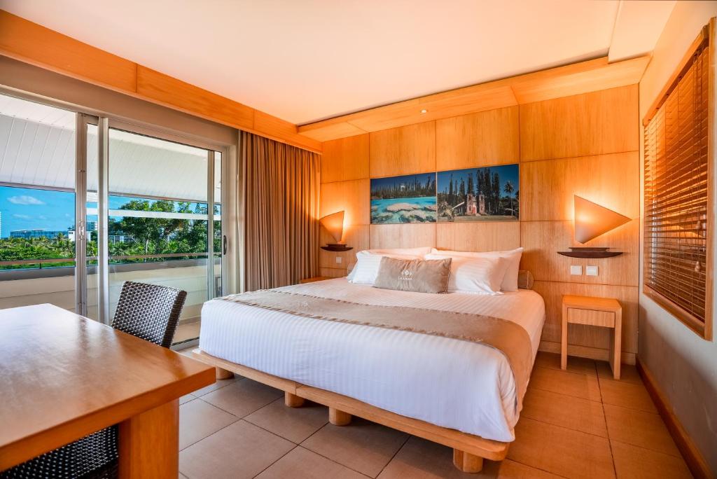 Katil atau katil-katil dalam bilik di Hôtel Le Lagon