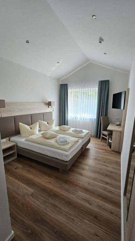 a bedroom with a large bed and a desk at Riverhouse in Nordenham