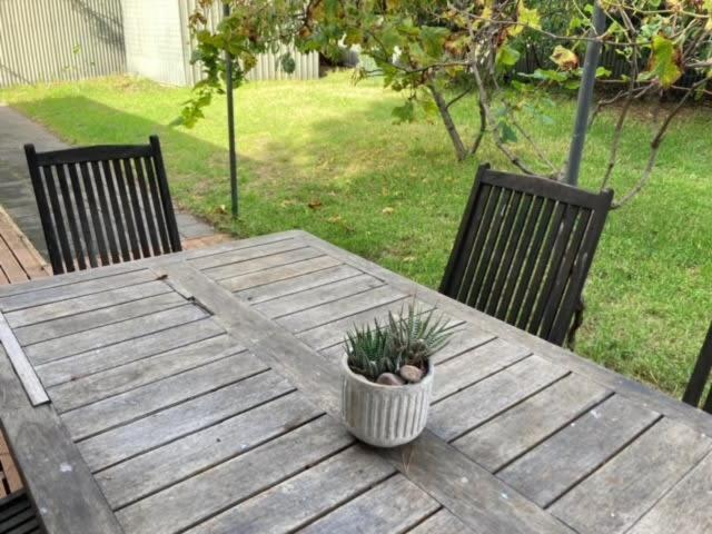 a wooden table with a potted plant on top of it at Carnegie House 3 Carnegie St Port Elliot - BYO Linen in Port Elliot