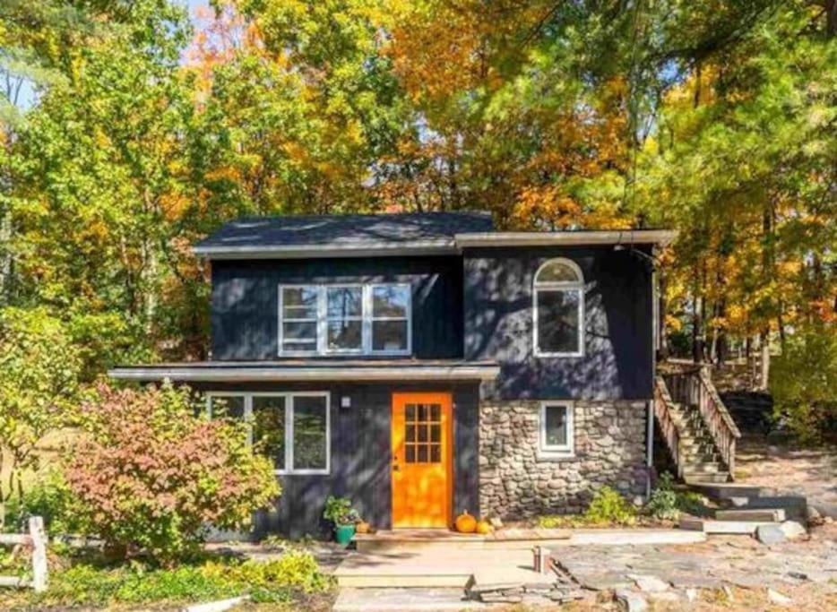 a small stone house with an orange door at Breezy Hill 3BR Modern & Quiet Home in Catskills in Accord