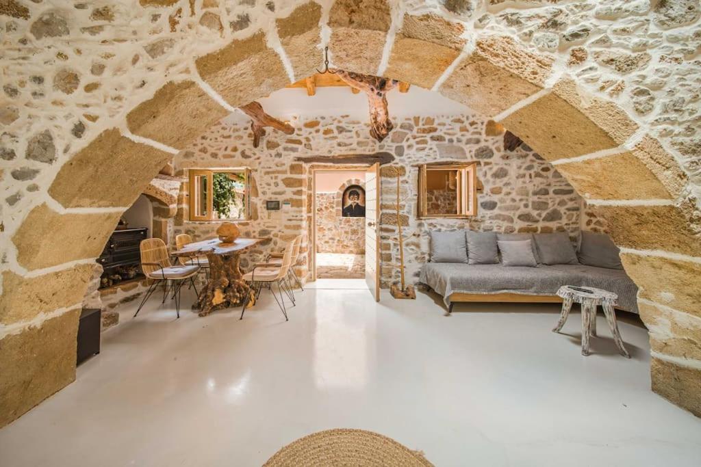 a living room with a couch and a table at Boutique Cretan house in Old Malia with Jacuzzi in Malia