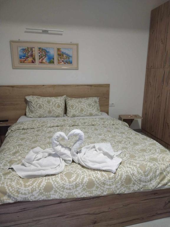 a bed with two towels in the shape of hearts at Apartments Prima in Ohrid