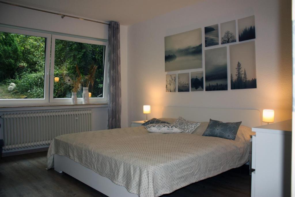 a bedroom with a bed and a large window at Auf dem Kleeberg in Niederzissen