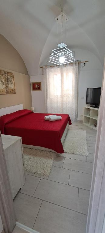 una camera con letto rosso e TV di FRANCAHOUSE a Catania