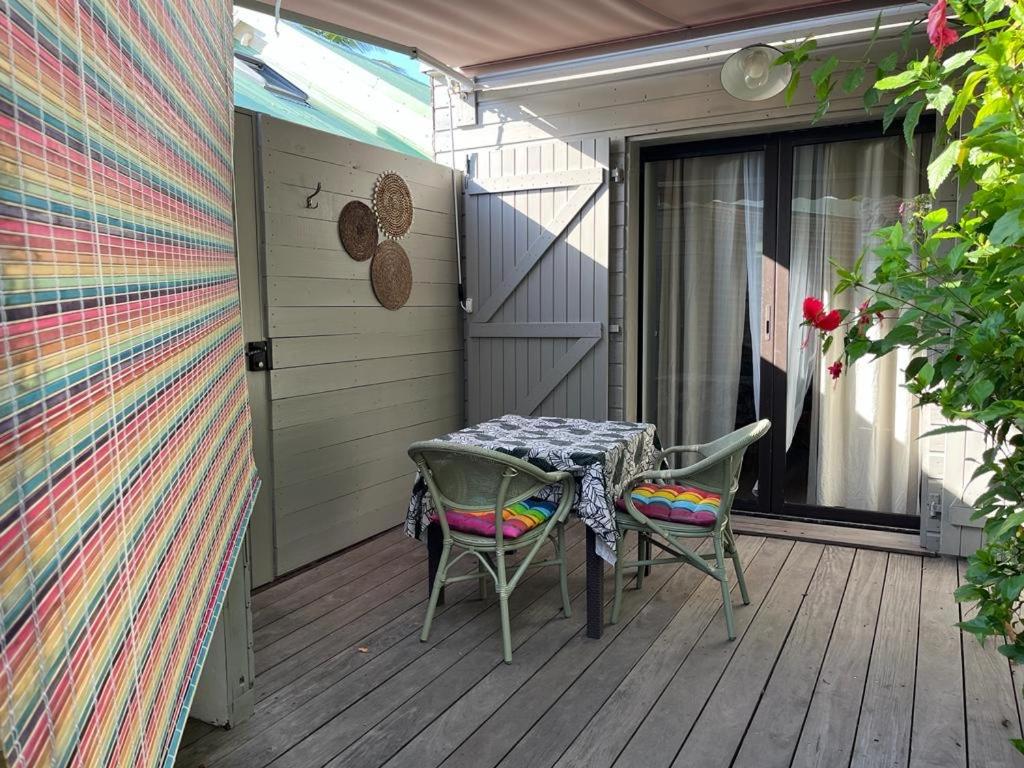 un patio con mesa y sillas en una terraza en Studio Soualiga Orient Bay en Saint Martin