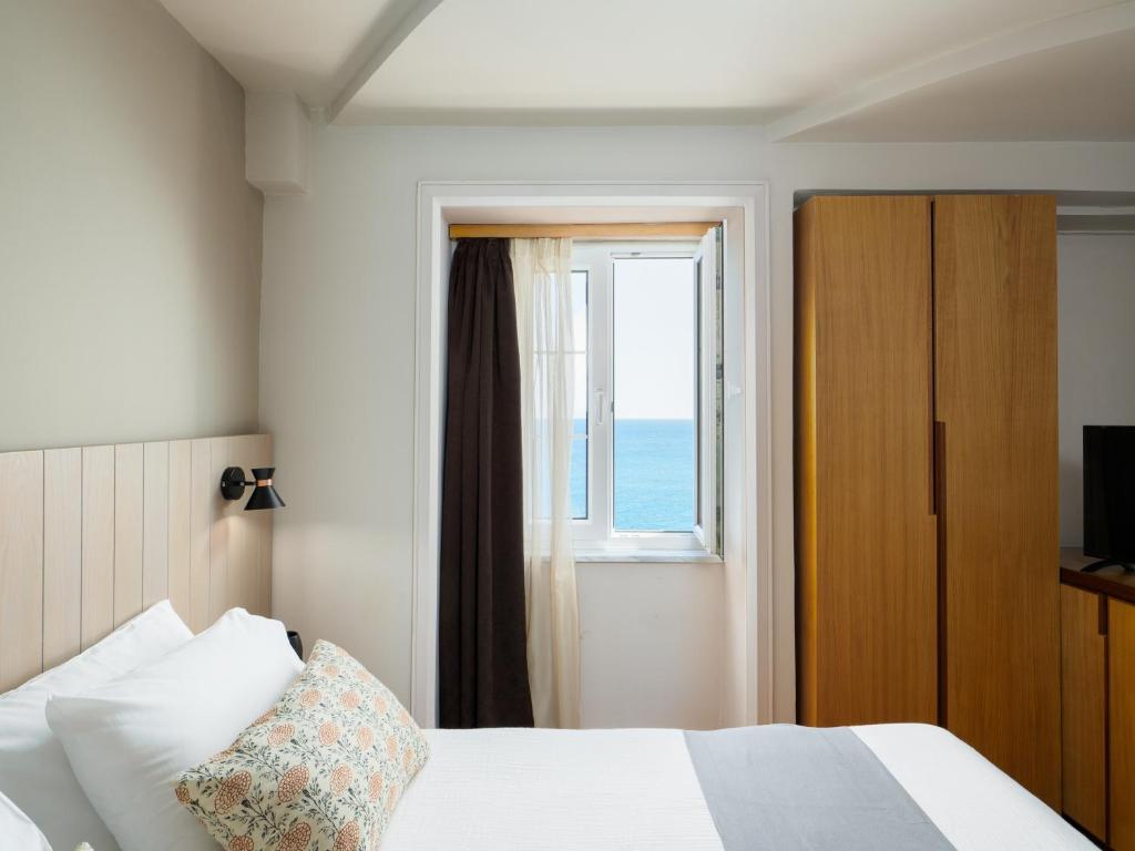 Postel nebo postele na pokoji v ubytování El Greco Hotel