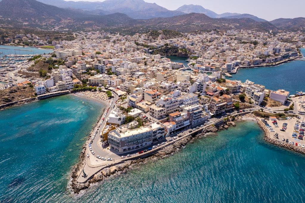 an aerial view of a town on the water at El Greco Hotel in Agios Nikolaos