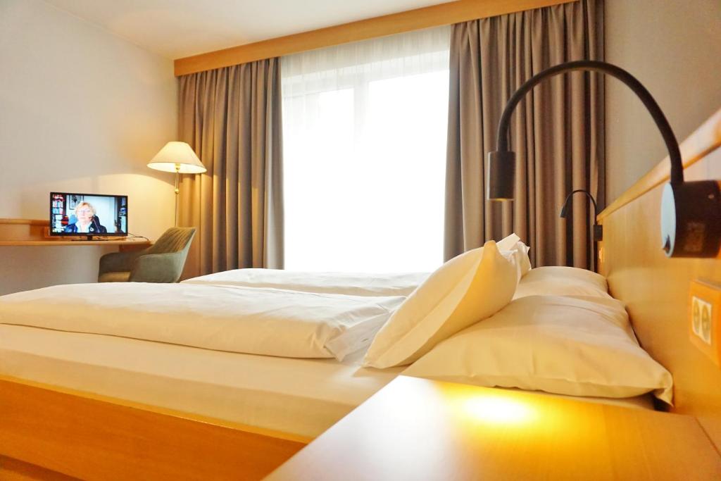 Postel nebo postele na pokoji v ubytování Hotel Brenner - Stop & Go