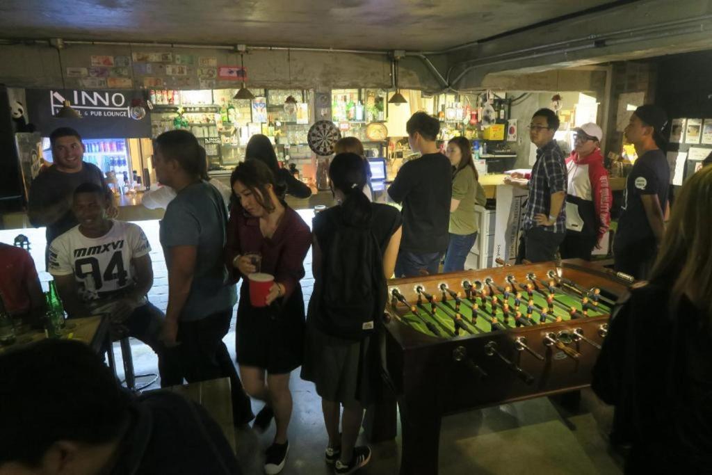 a group of people standing in a store at INNO Hostel & Pub Lounge Hongdae in Seoul