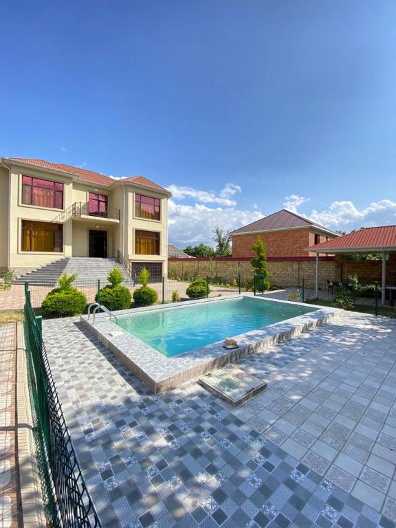 a swimming pool in front of a house at Villa in Gabala in Gabala