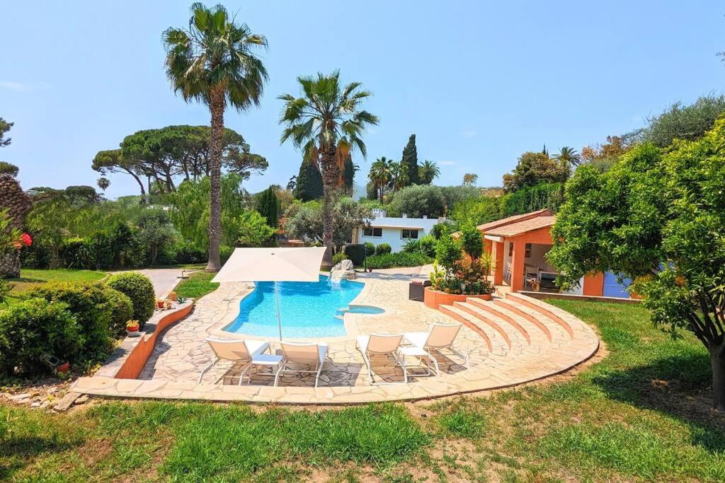 une piscine avec des chaises et une maison dans l'établissement Dream Villa 300m2 & stunning 4000m2 private garden, à Cannes