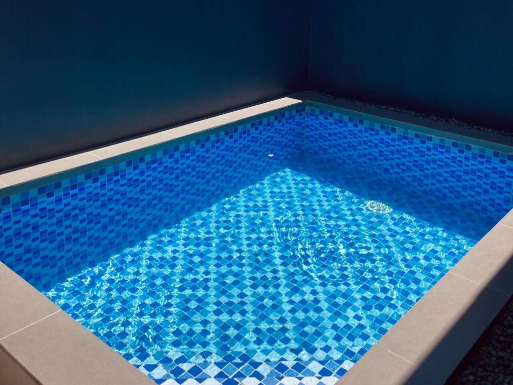 una gran piscina con azulejos azules en una habitación en Loft-type Pool Villa near Clark (Casa Isabela), 
