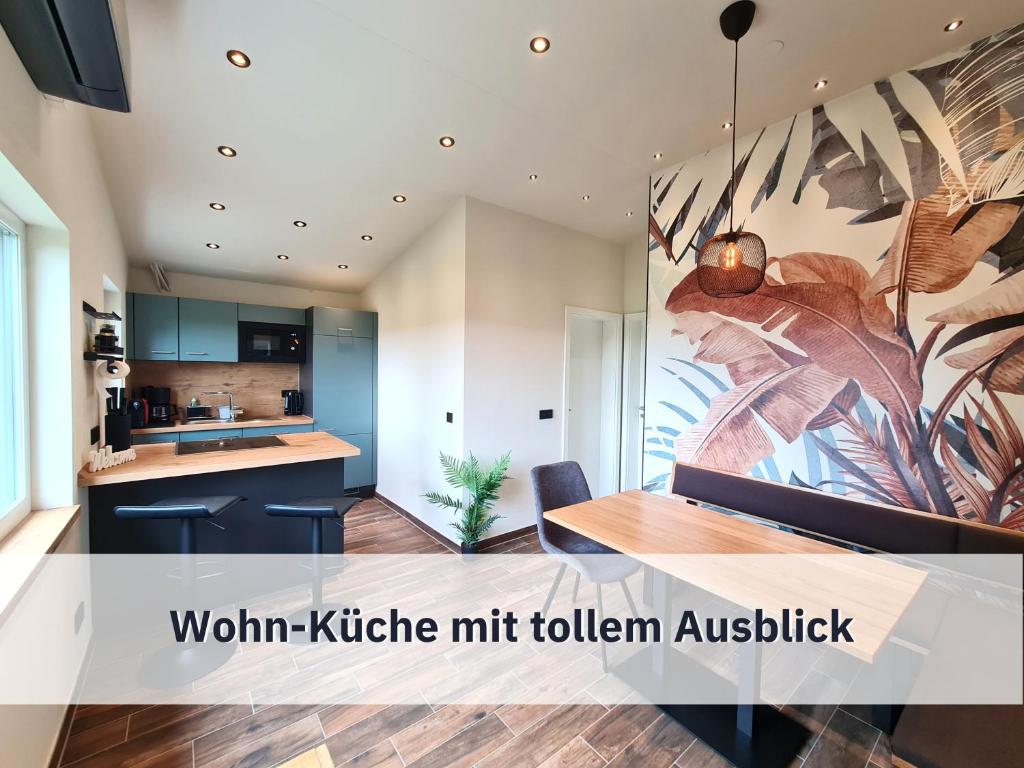 a kitchen with a large painting on the wall at Ferienhaus Rothsee-Oase ideale Ausgangslage mit tollem Ausblick, Sauna und privatem Garten in Roth