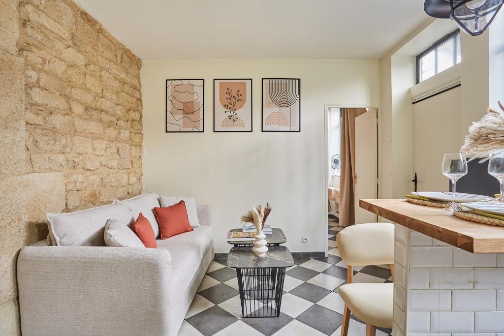 a living room with a couch and a table at Apartment Center of Paris by Studio prestige in Paris