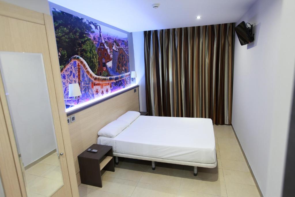 a hotel room with a bed and a projection of a train at Hostal Las Flores Ramblas in Barcelona