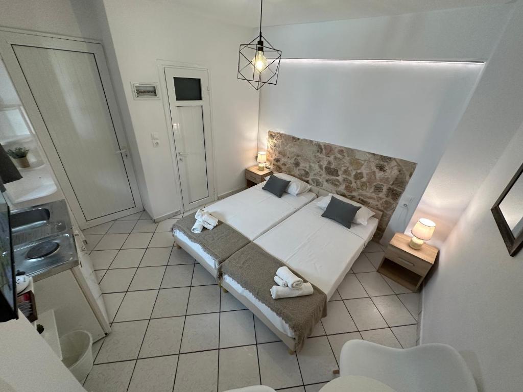 a small bedroom with a bed and a bathroom at Valente Rooms Kythira in Kythira