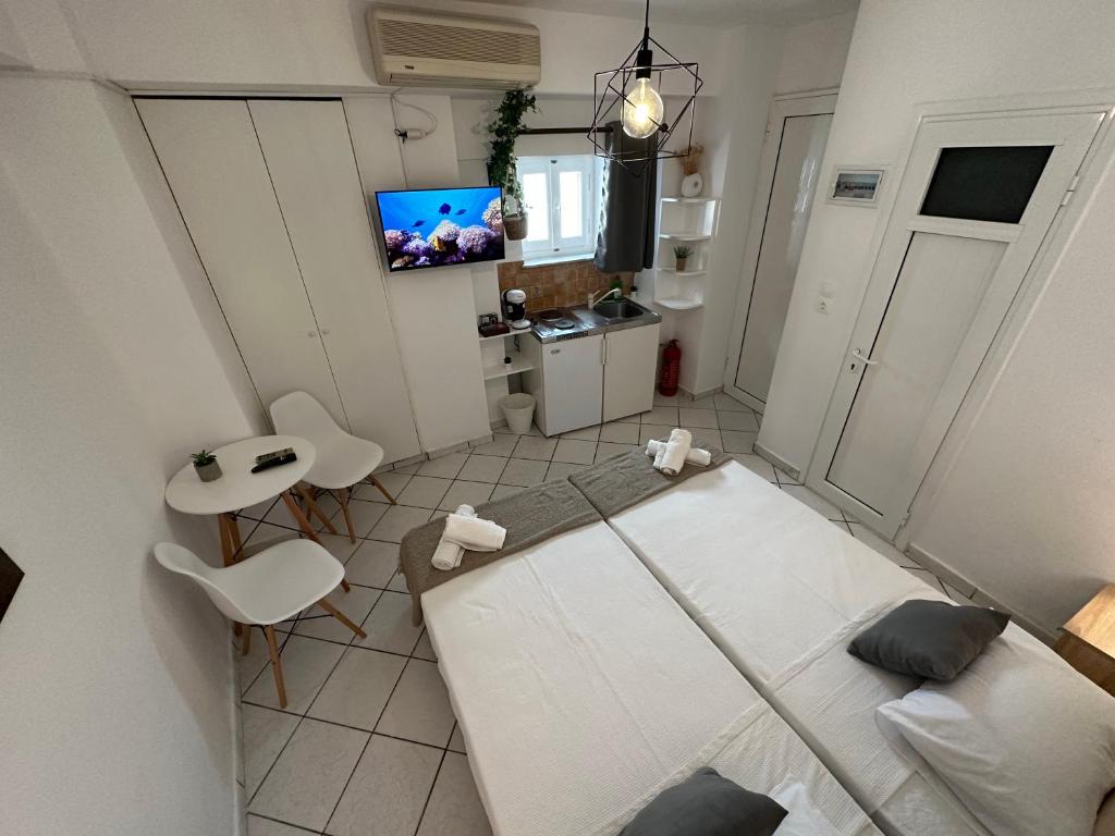 a small room with a bed and a tv at Valente Rooms Kythira in Kythira