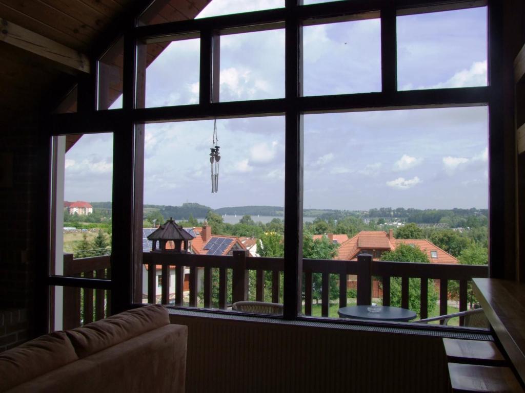 a view from a large window of a house at Panorama Mikołajki Mazurski-zakątek in Mikołajki
