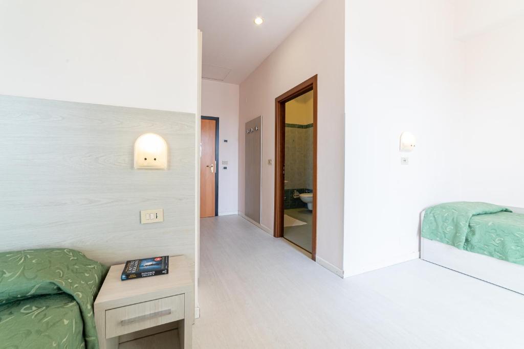 Postel nebo postele na pokoji v ubytování Hotel Royal