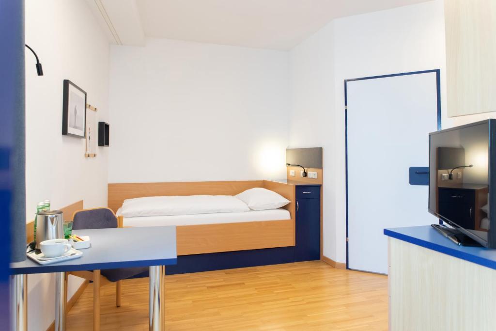 Postelja oz. postelje v sobi nastanitve JUFA Hotel Garni Stubenberg am See