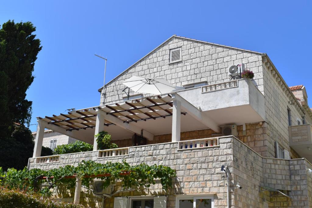 a building with an umbrella on top of it at Bel Posto Apartment in Dubrovnik