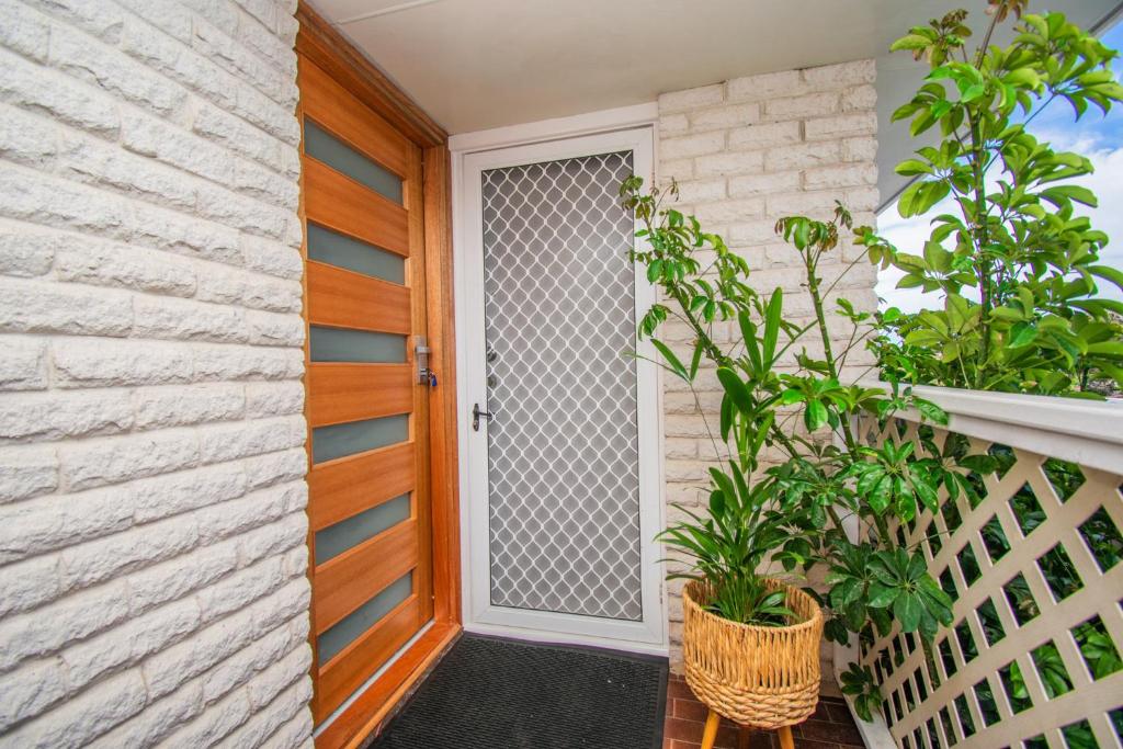 a front door of a house with plants at Gairdner Cottage - something a bit different! in Albany
