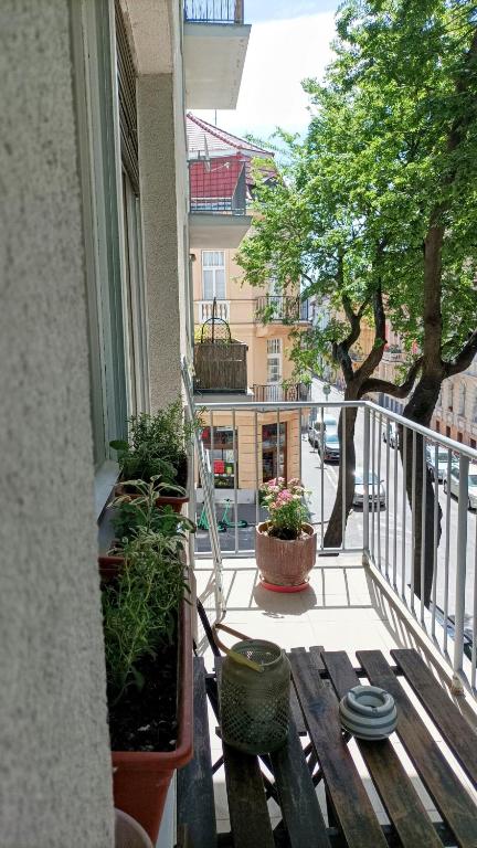 a balcony with a wooden bench on a balcony at nice flat under the castle in Bratislava