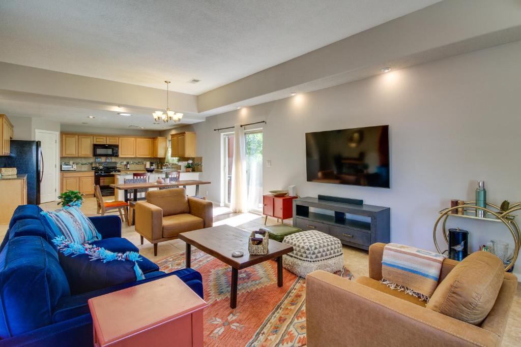 a living room with blue couches and a tv at Pet-Friendly Albuquerque Vacation Escape! in Albuquerque