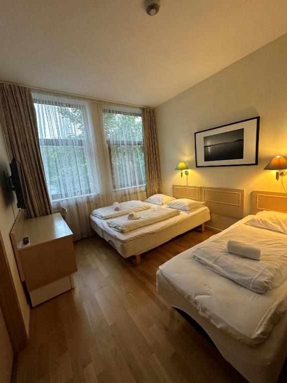 Postel nebo postele na pokoji v ubytování Mitt hotell & apartments