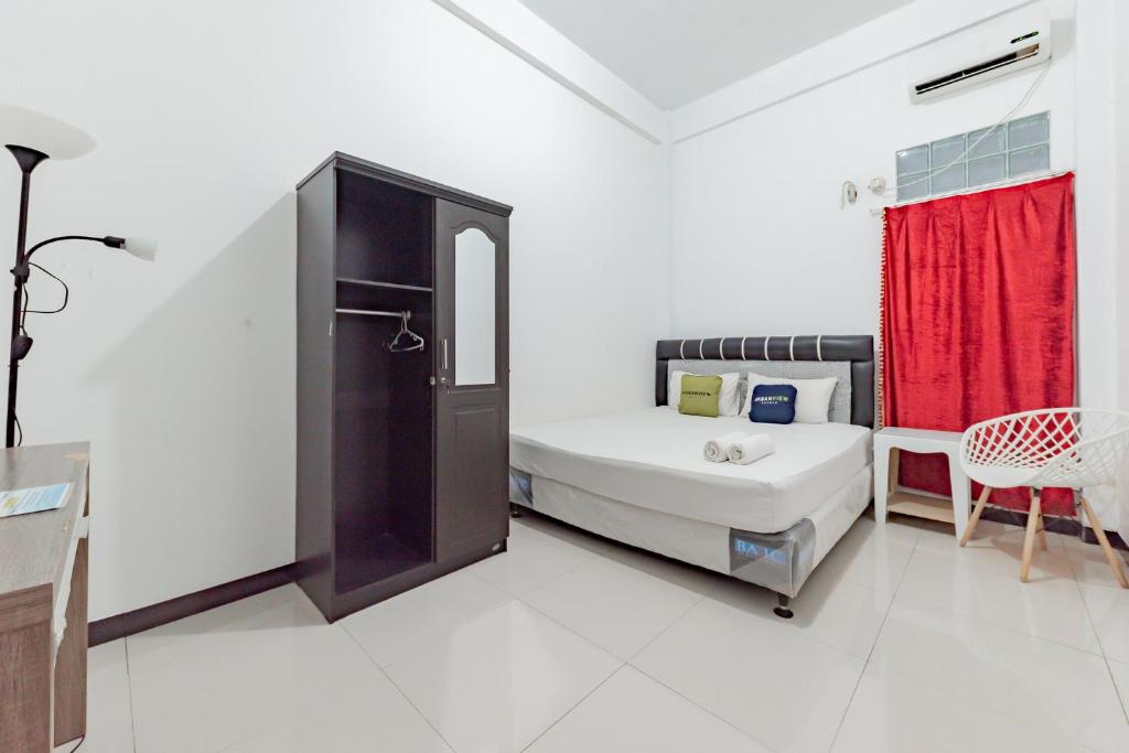 Postel nebo postele na pokoji v ubytování Urbanview Hotel 99 Syariah Banjarbaru by RedDoorz