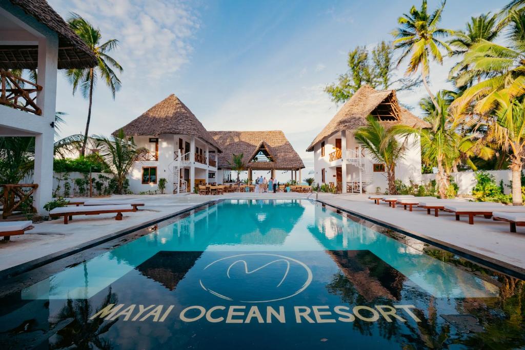 a swimming pool in front of a villa at Mayai Ocean Resort in Bwejuu