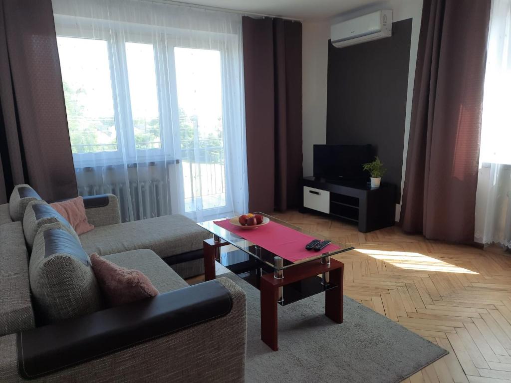 a living room with a couch and a coffee table at Travel Apartament Cracow in Kraków