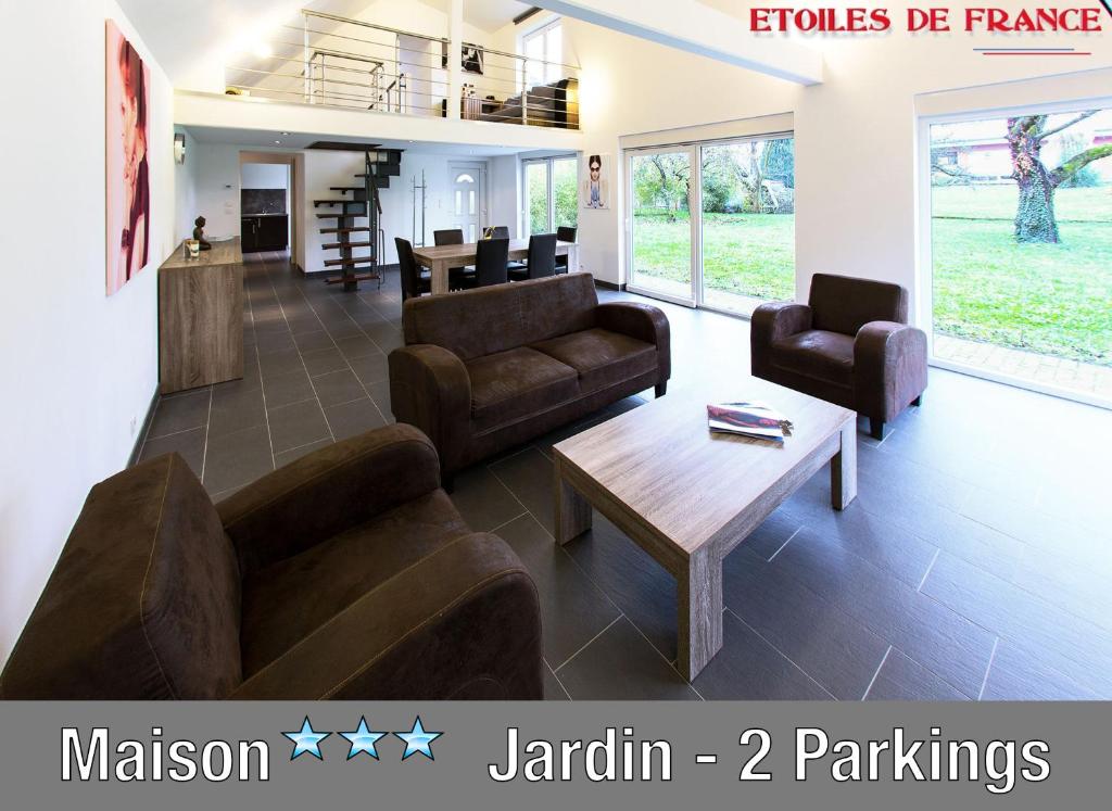 a living room with two couches and a coffee table at SFK -Maison Moderne-Jardin-Parking-10mn Strasbourg in Vendenheim