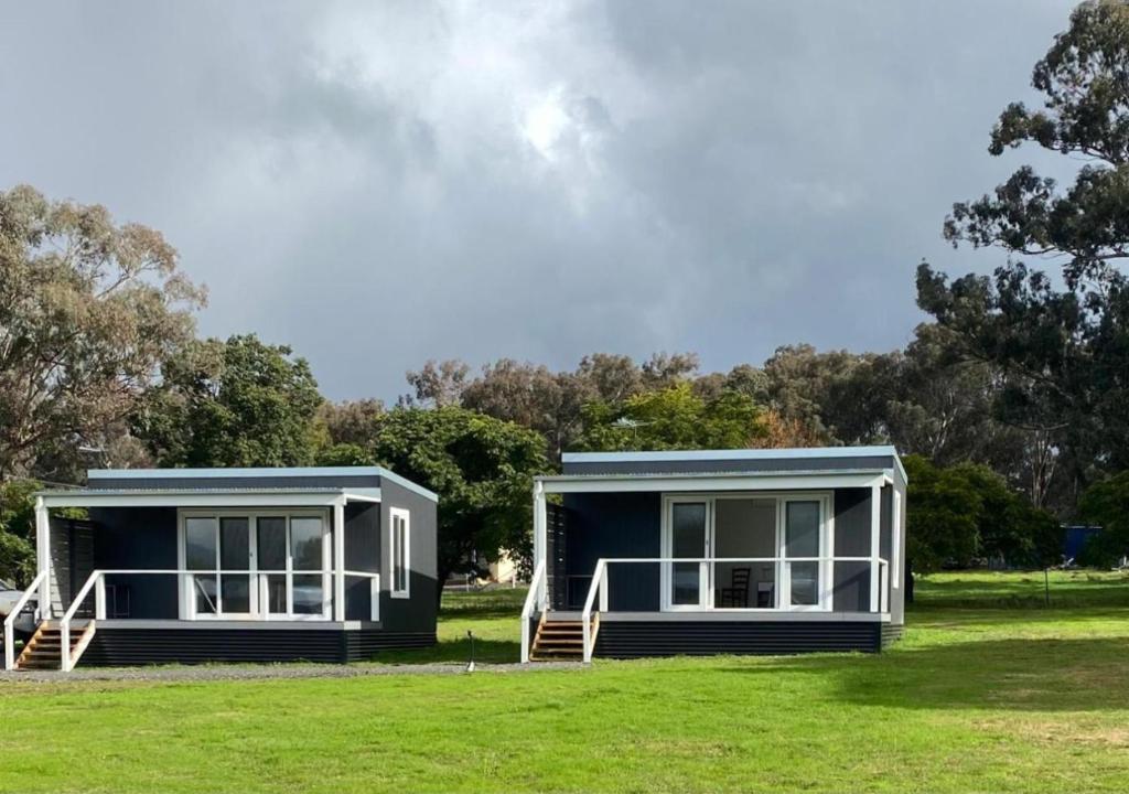 two modular homes sitting on a grass field at Historic Cargo Inn Orange Food & Wine Region 