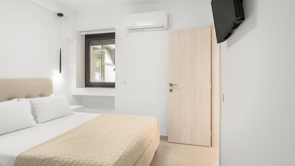 Postel nebo postele na pokoji v ubytování Agni Suites